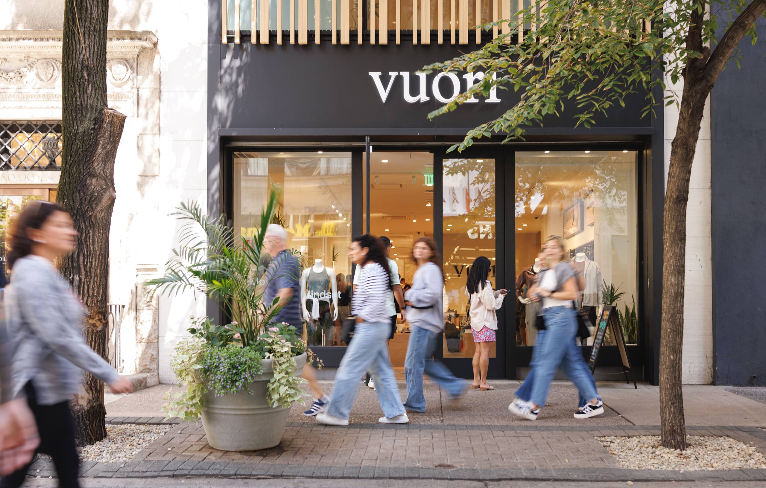 Vuori store exterior with people walking by.
