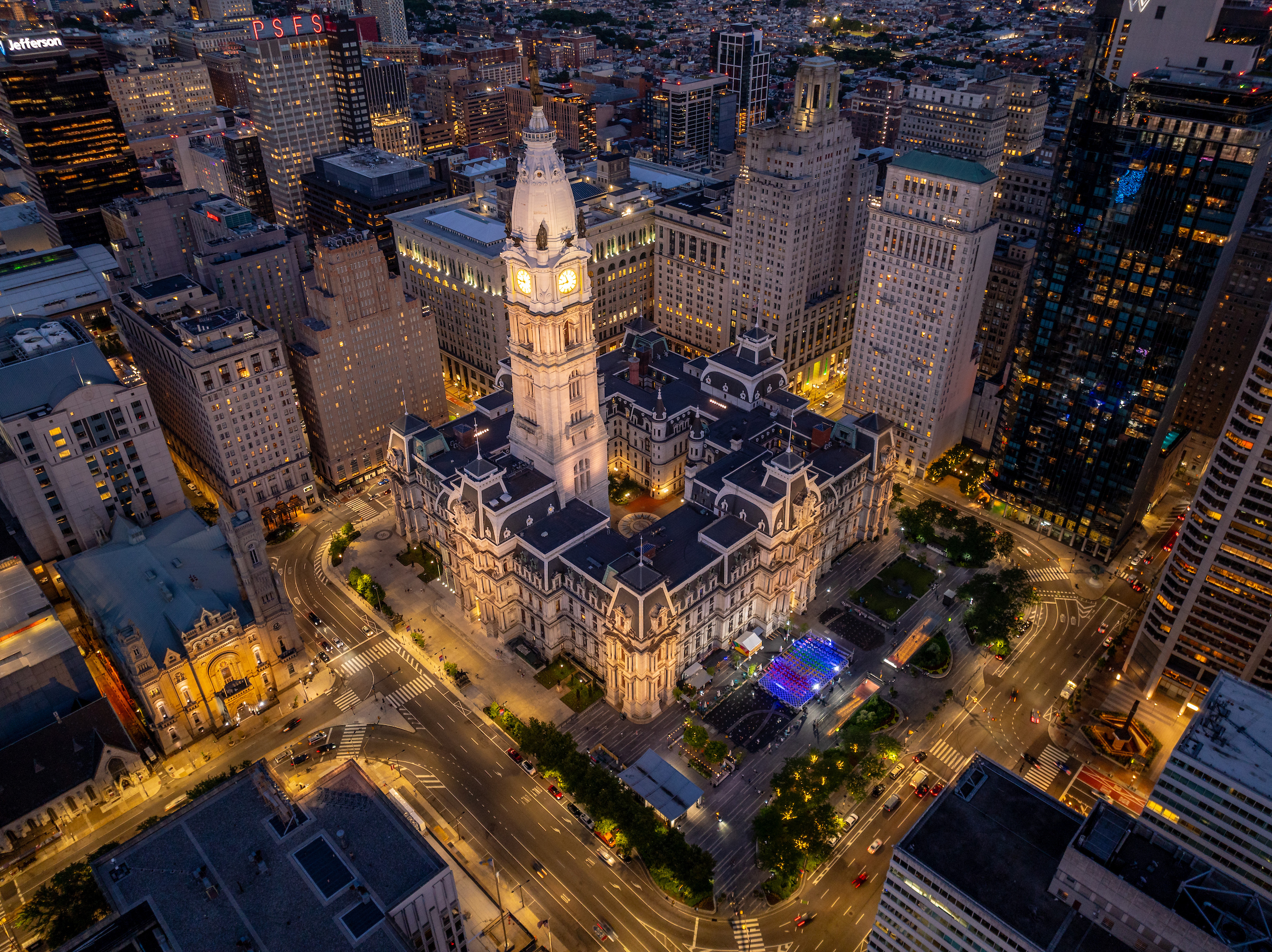 Philadelphia's City Hall lit with white light at night.